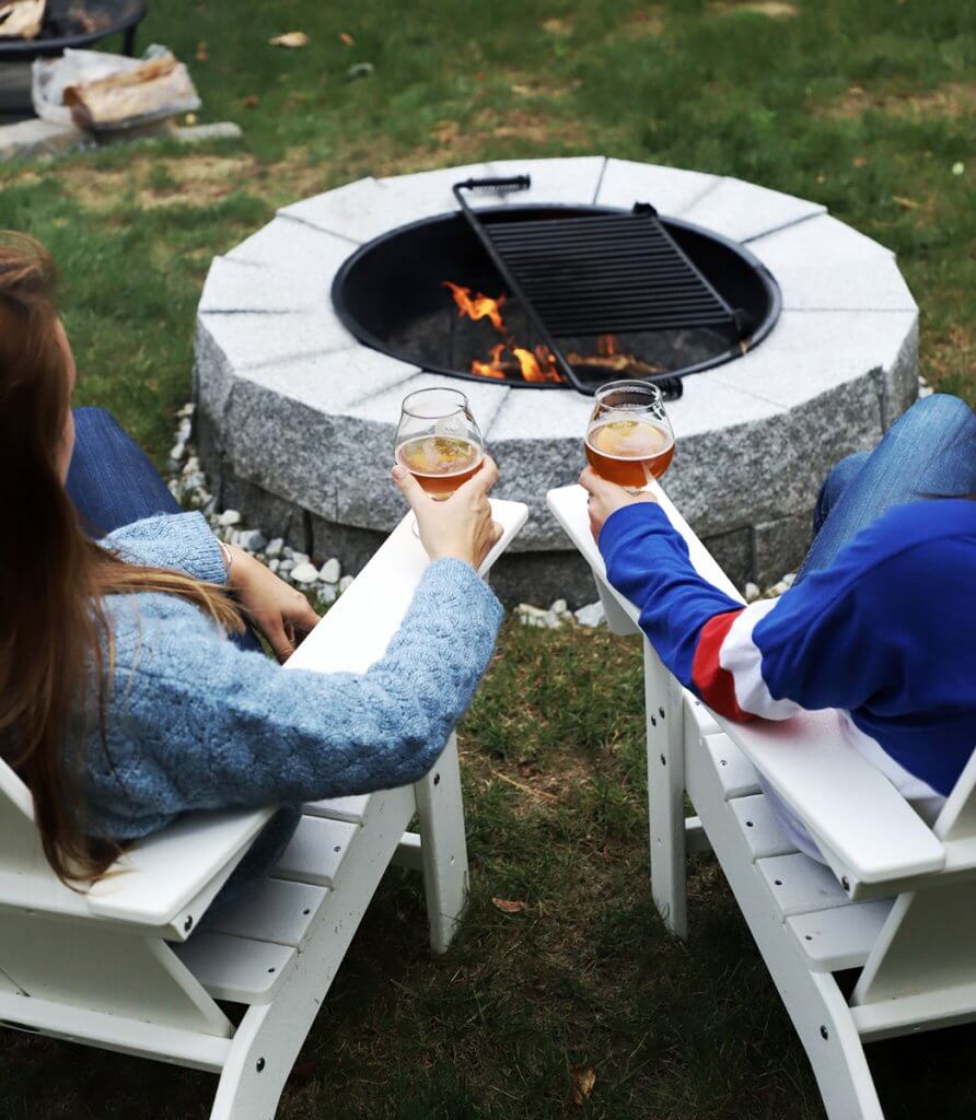 Image of a couple enjoying a beverage at a fire pit